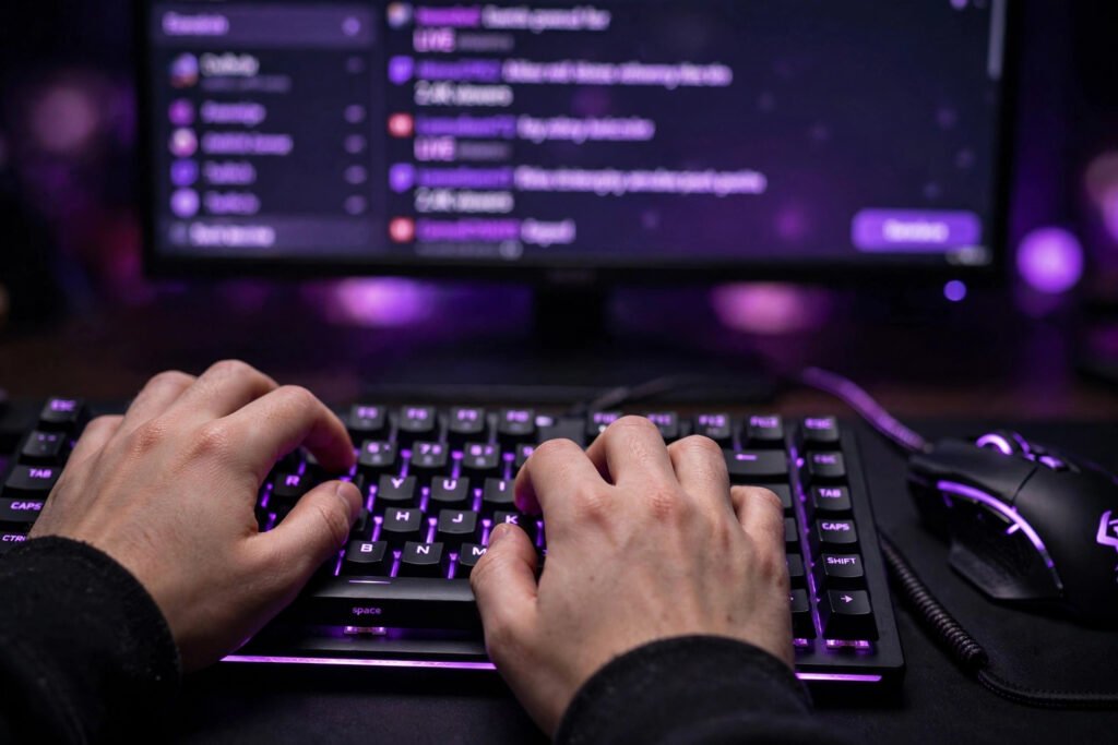 Hands on an RGB keyboard during a live Twitch stream with chat on screen
