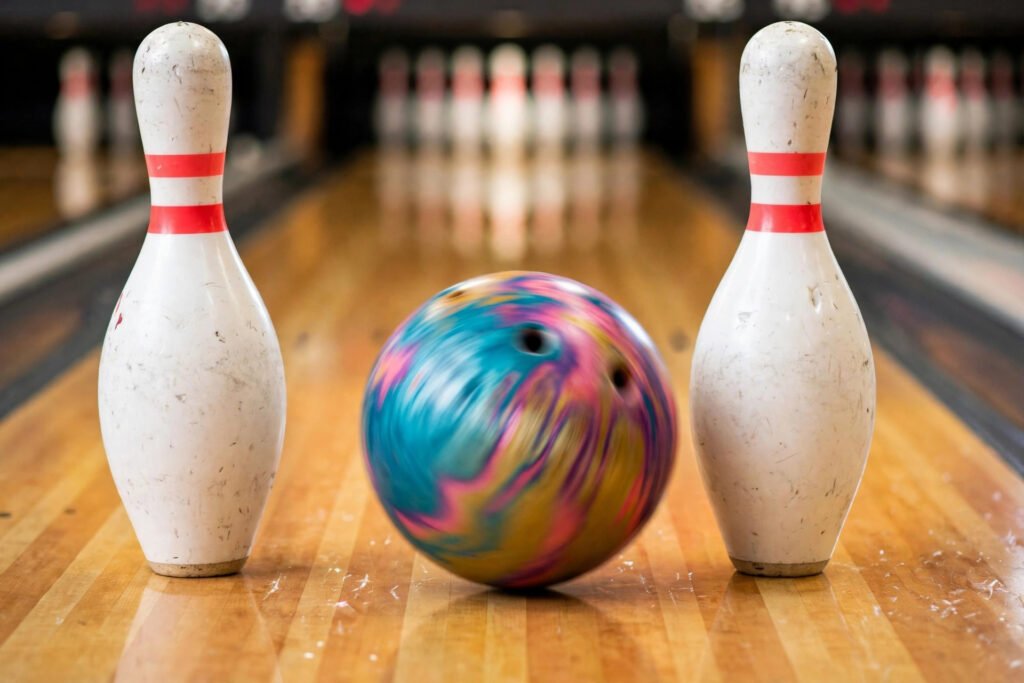 Bowling ball rolling toward white pins on a polished lane, the fun behind funny bowling team names